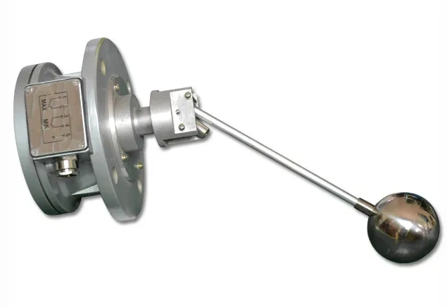 A side view of the oil level indicator showing the transparent sight glass, protective metal housing, and clear measurement graduations mounted on a flange.
